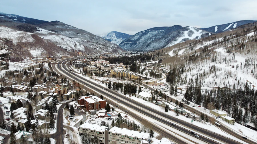 Interstate 70 running through the Vail valley below the ski terrain in winter.