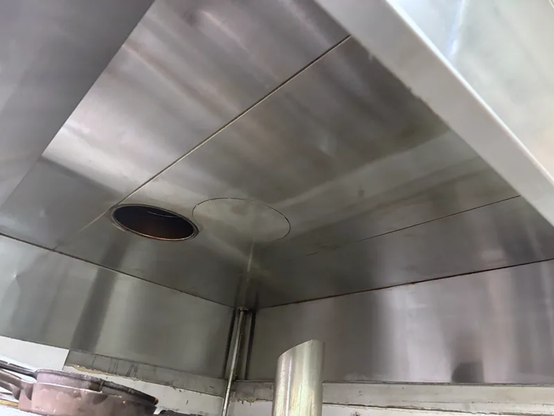Restaurant hood plenum after cleaning, panels back to bare stainless steel, Denver.